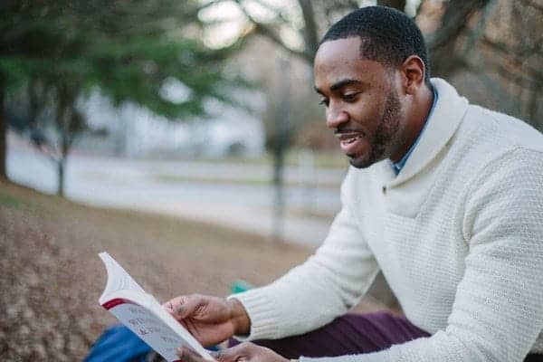 Man In White Sweater Reading Book