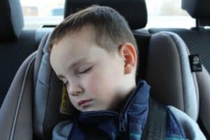 A boy sleeps in a Britax car seat