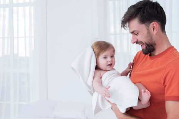 Father Holding Baby in Towel