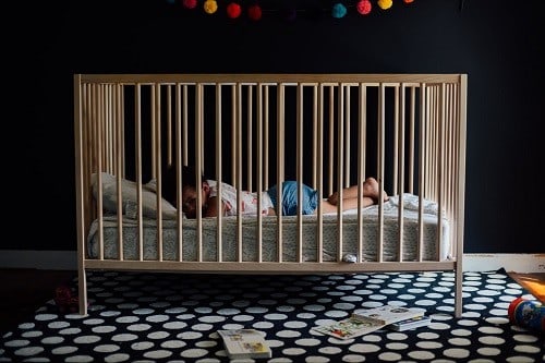 toddler inside the crib