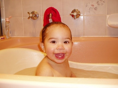 baby taking a bath in a bath tub