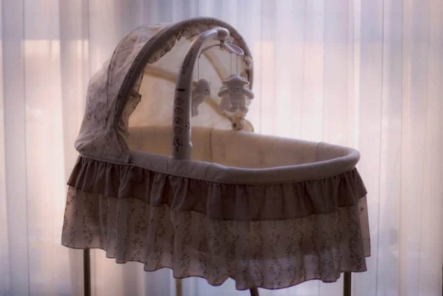 baby bassinet backlit by a window
